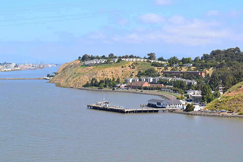 Vallejo shoreline with a pier and hillside homes along the water